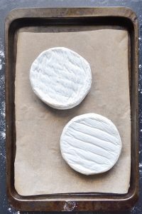 brie rounds placed on baking sheet