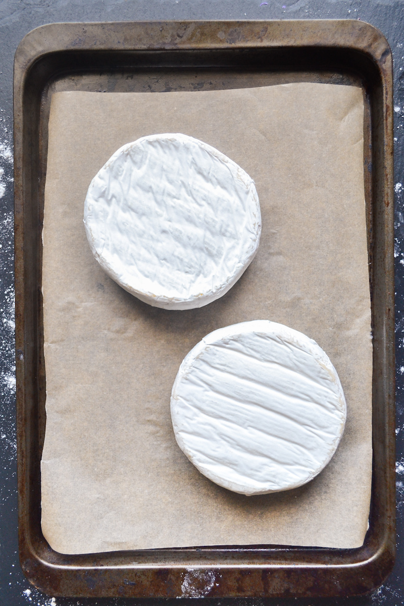 brie rounds placed on baking sheet