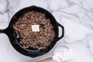 butter added to pan with mushrooms