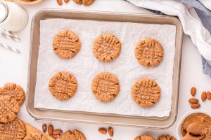 cooked almond butter cookies on a baking sheet