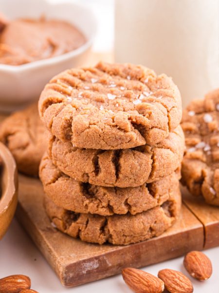Almond Butter Cookies stacked on a cutting board