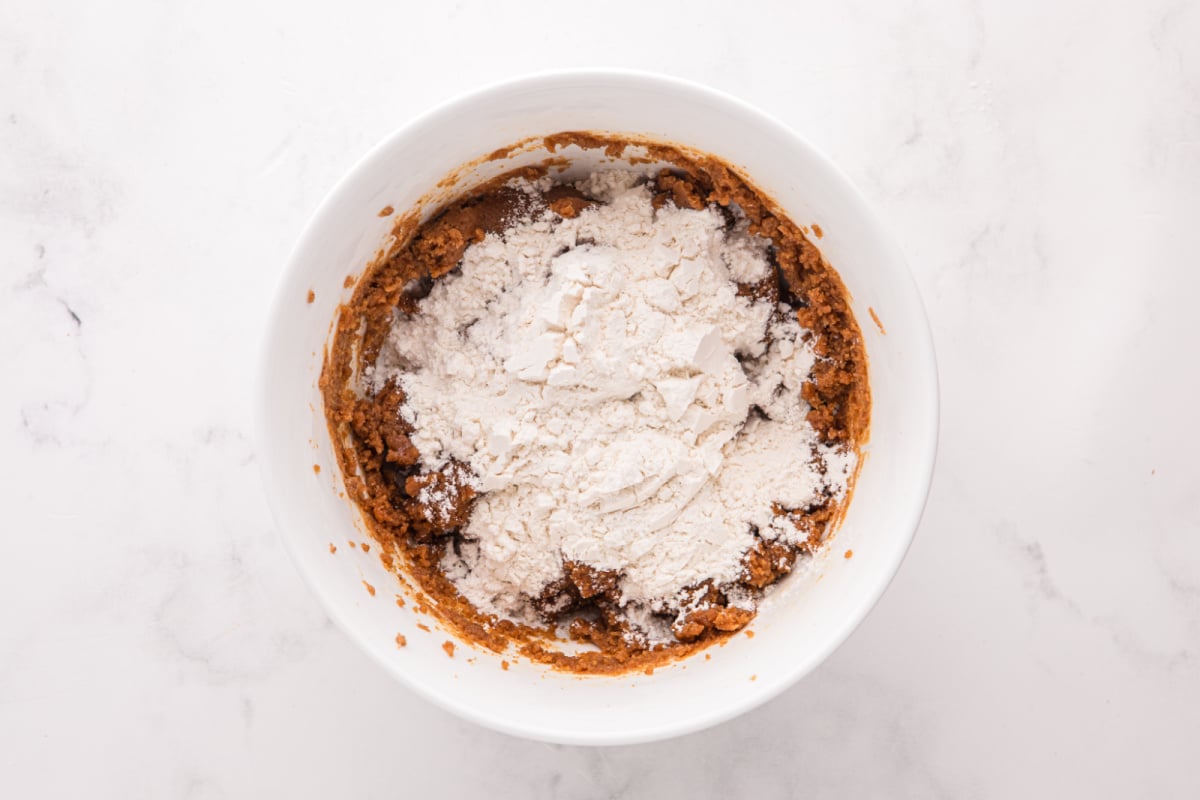 slowly adding flour mixture to bowl