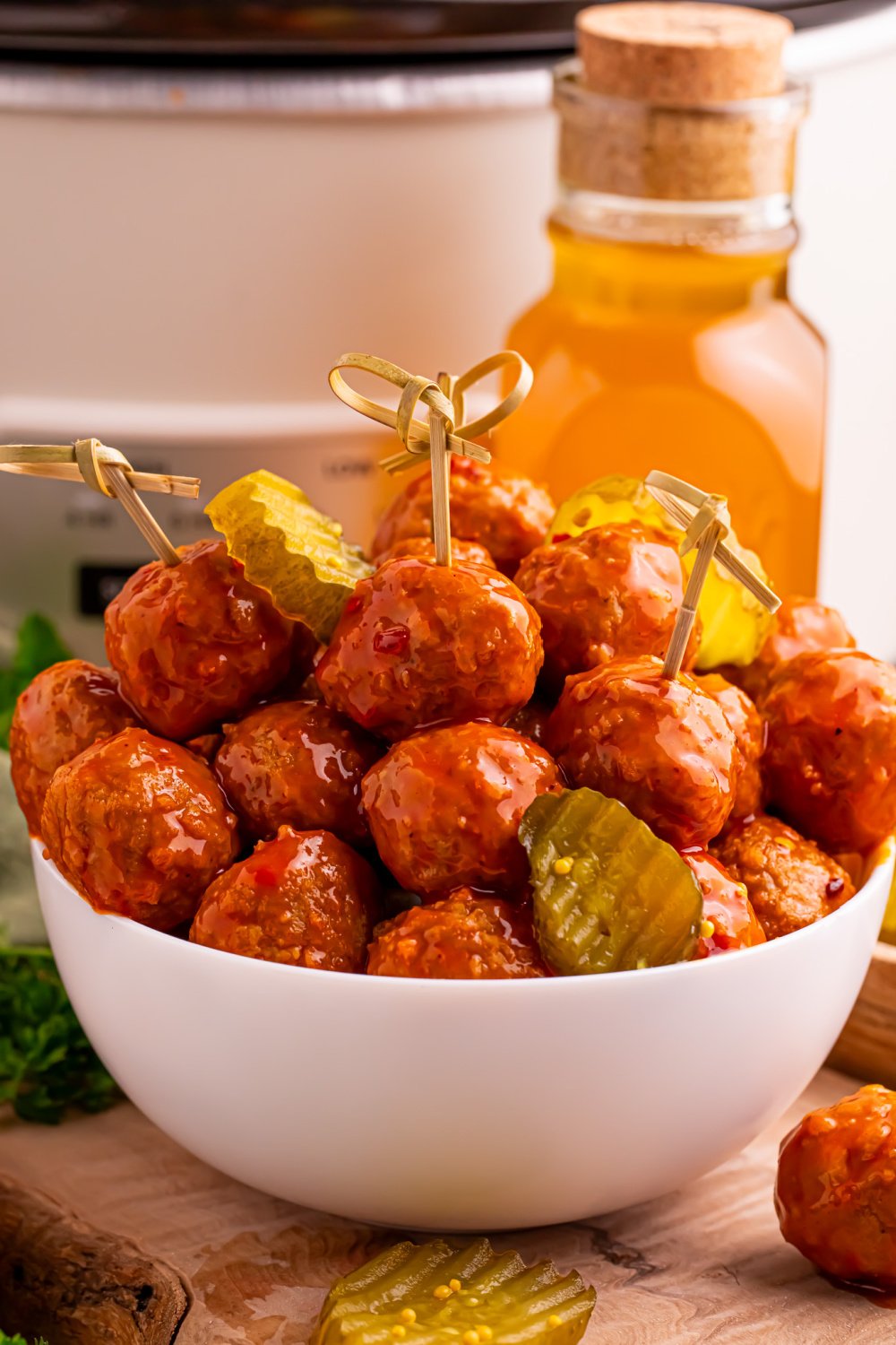 Slow Cooker Hot Honey Meatballs in a bowl with pickles