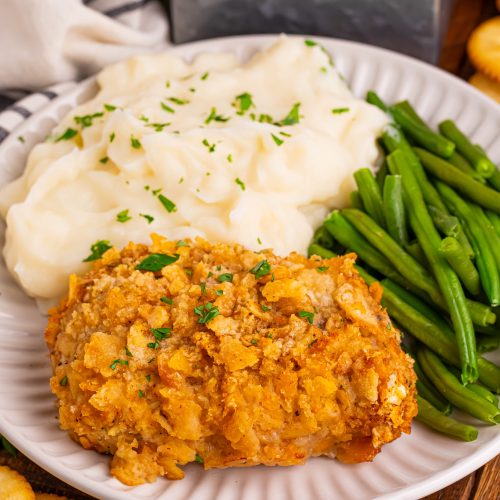 Baked Ritz Pork Chops on a plate with mashed potatoes and green beans
