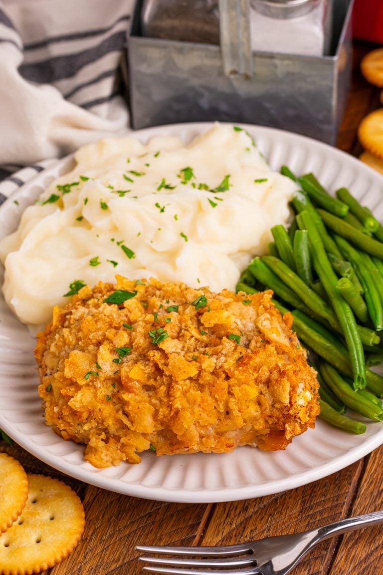 Baked Ritz Pork Chops on a plate with mashed potatoes and green beans