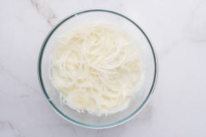 onions in a bowl with buttermilk