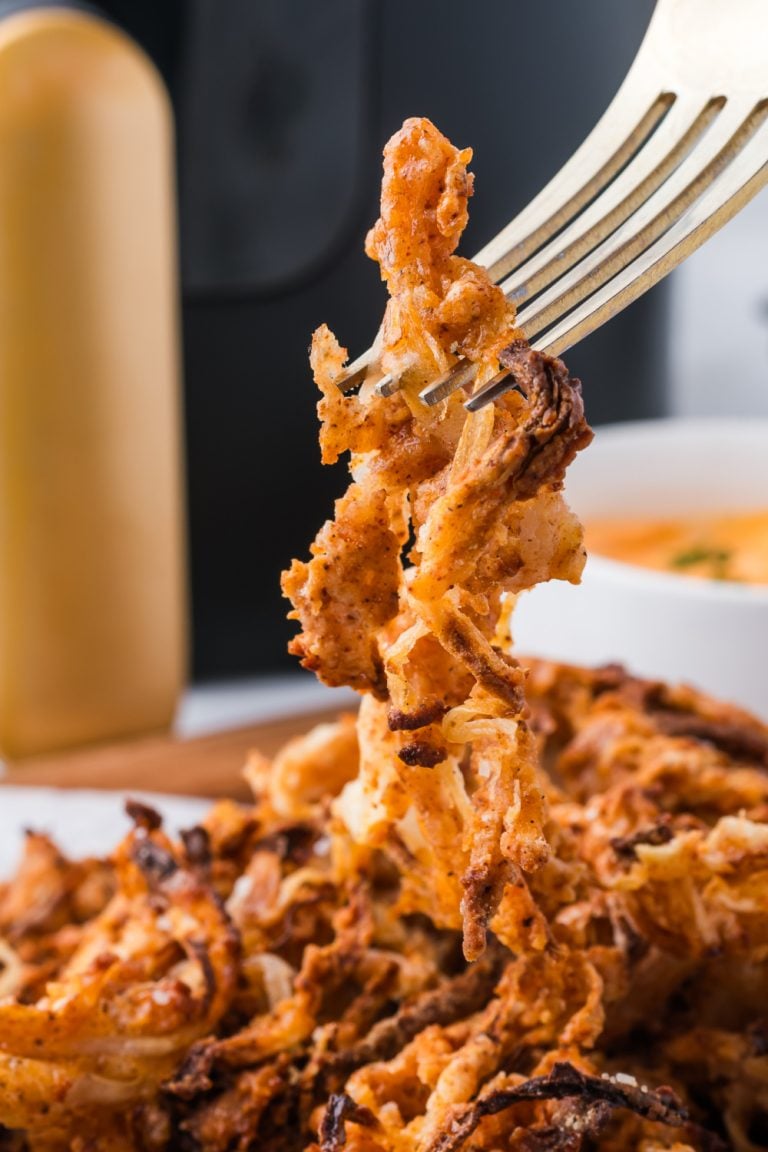 Air Fryer Onion Strings picked up with a fork