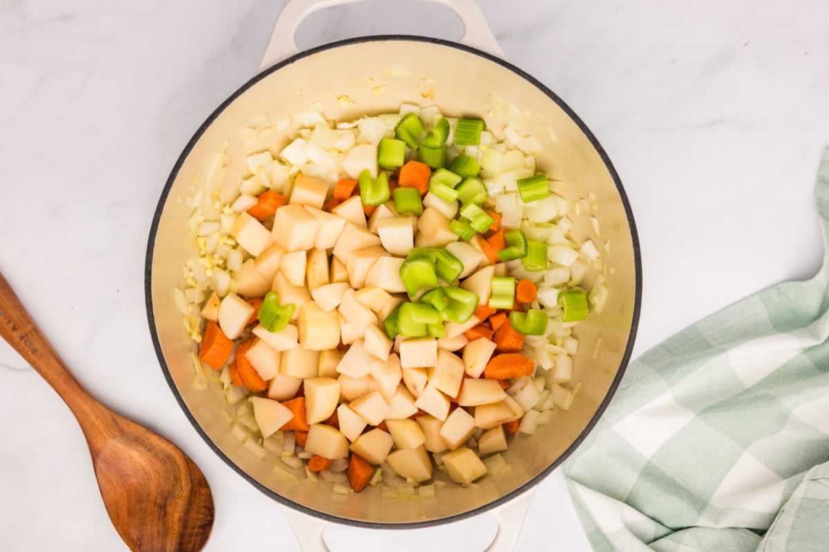 garlic, carrots, celery, and potatoes added to the pot