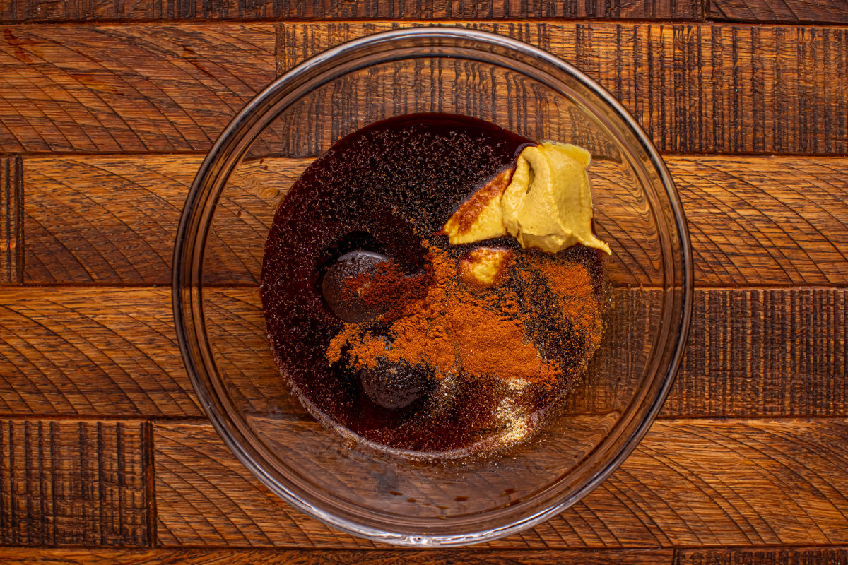 maple syrup, brown sugar, Dijon mustard, soy sauce, apple cider vinegar, garlic powder, cinnamon, and cloves in a bowl