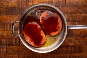 sauce added. to pan with ham steaks