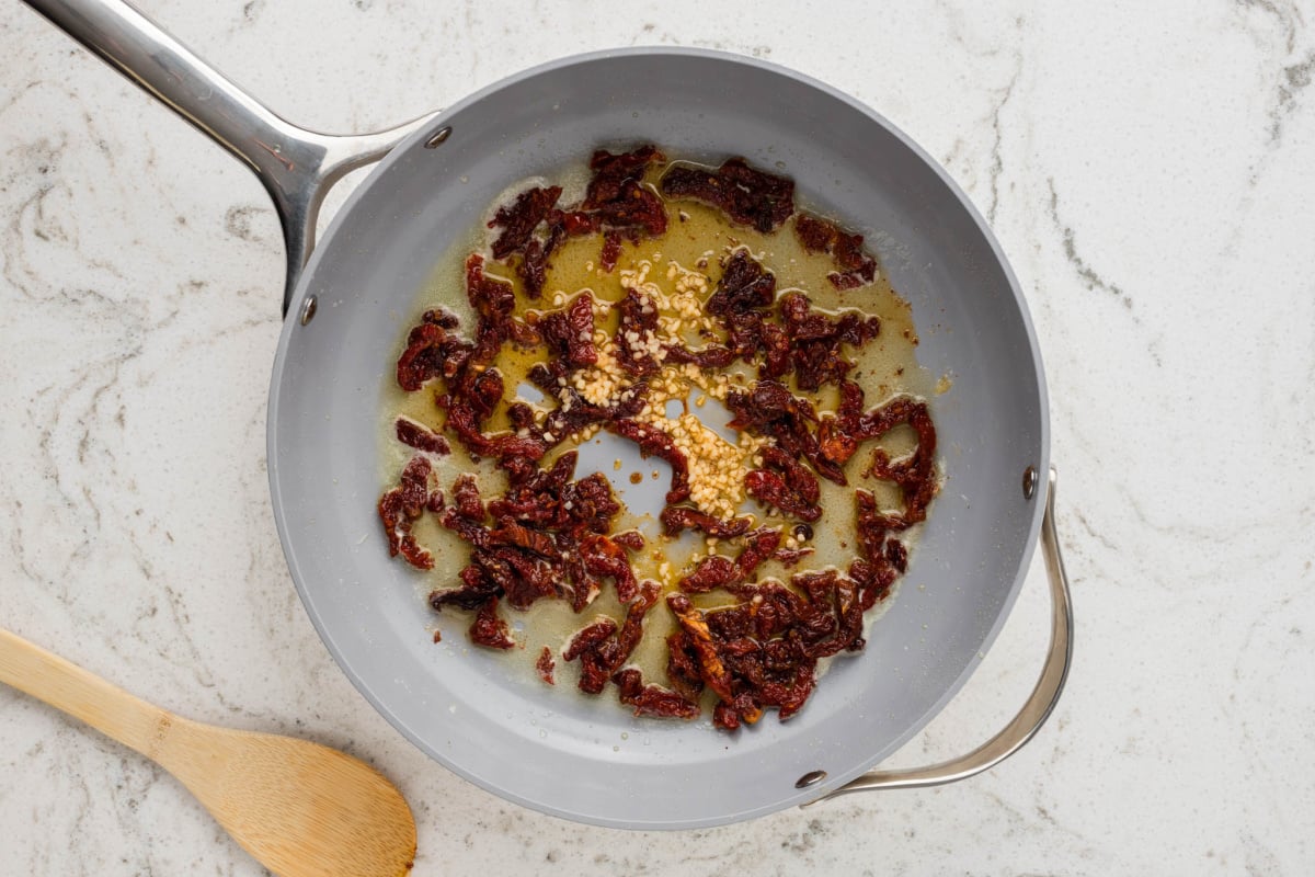 butter, garlic and sun dried tomatoes in a pan