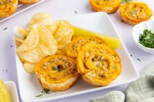 Tuna Melt Bites on a plate with chips and pickle