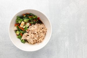 shredded chicken and mixed veggies add ed to the bowl