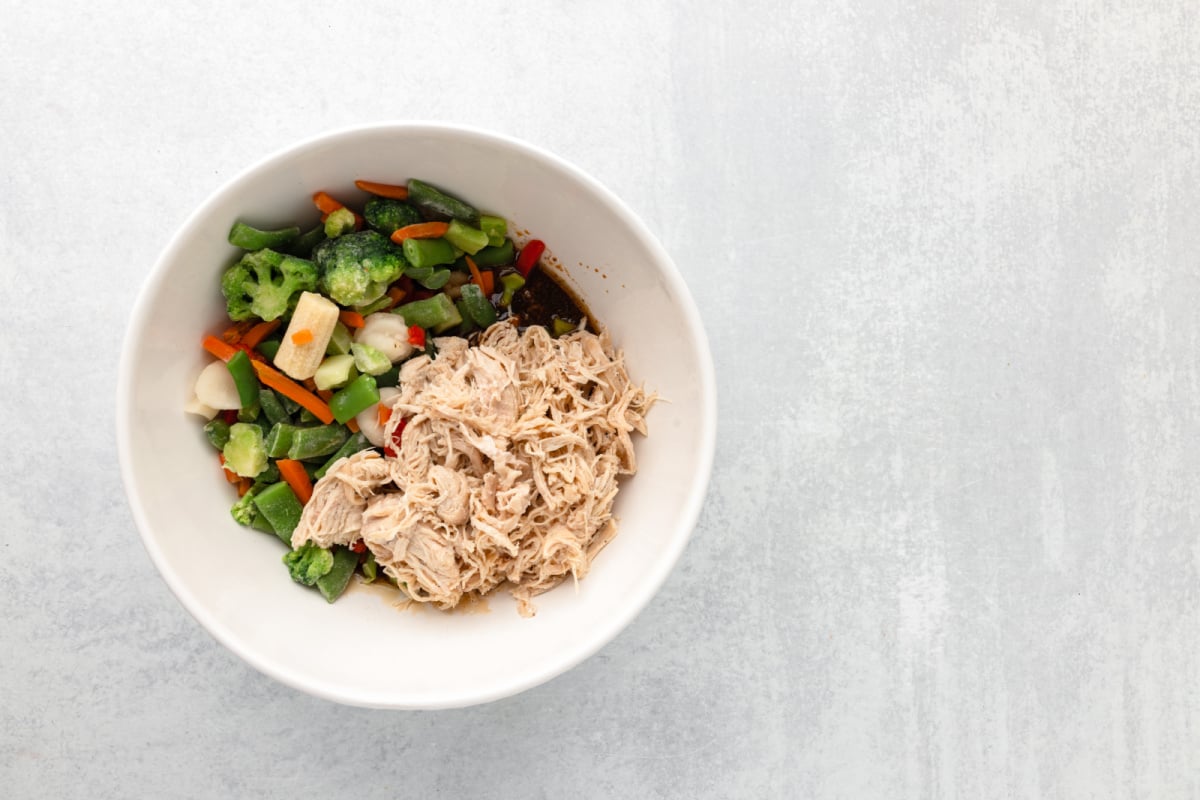 shredded chicken and mixed veggies add ed to the bowl