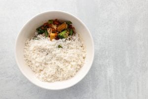 cooked rice added to the bowl with chicken mixture