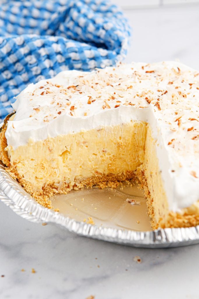 Homemade Coconut Cream Pie with piece cut out