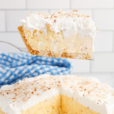 A slice of Homemade Coconut Cream Pie on a spatula
