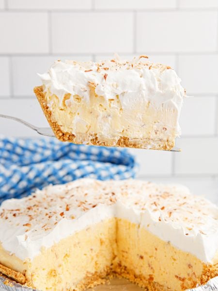 A slice of Homemade Coconut Cream Pie on a spatula