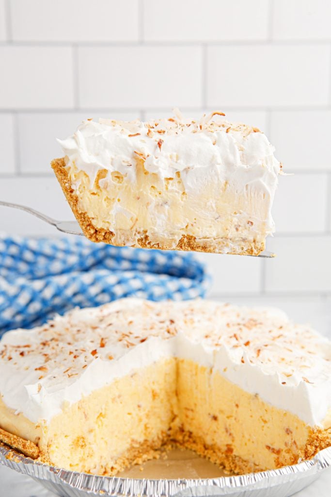 A slice of Homemade Coconut Cream Pie on a spatula