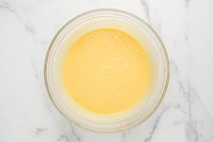 vanilla pudding, sweetened condensed milk and cold milk in a bowl