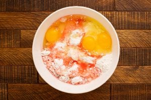 cake mix with eggs, vegetable oil, water, maraschino cherry juice, and almond extract in a bowl