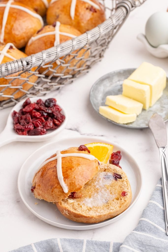 hot cross buns with butter spread on it