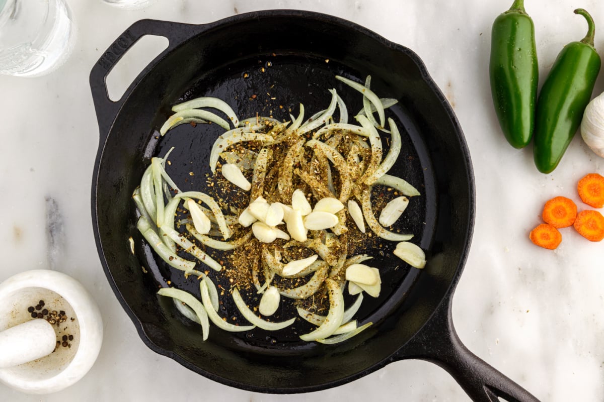 Add garlic, cumin, oregano and salt to the pot