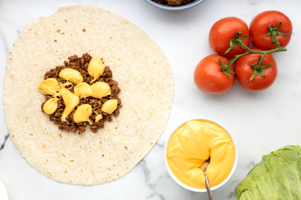 Nacho cheese added to the top of beef