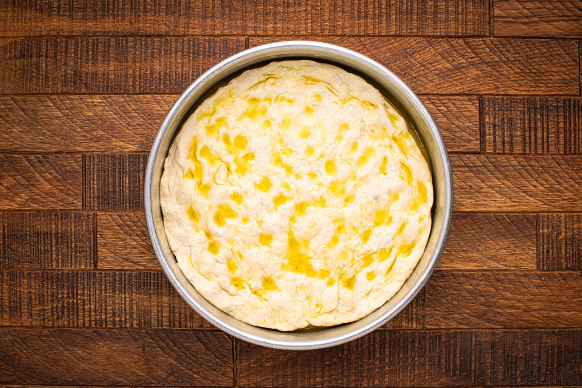 Dough in a pan with olive oil on top