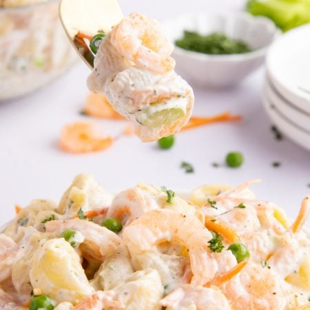 Mermaid Shrimp Pasta Salad in a bowl with a fork picking up some