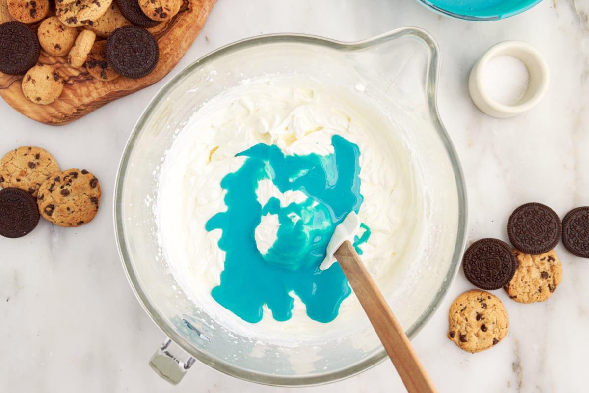 whipped cream in a bowl with some blue mixture 