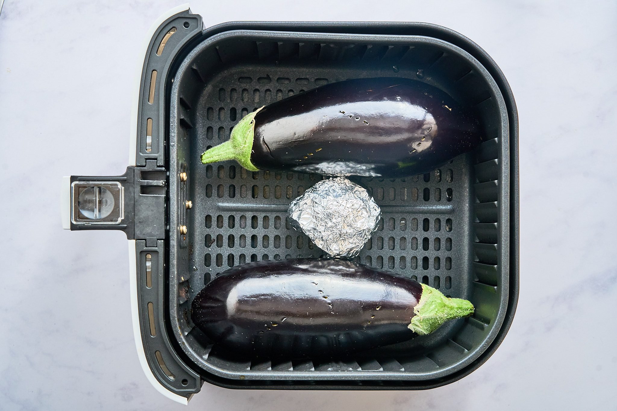 egg plants and garlic wrapped in foil in the air fryer
