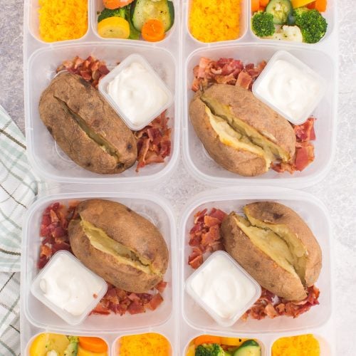 baked potatoes in lunchboxes with cheese, bacon and mixed veggies
