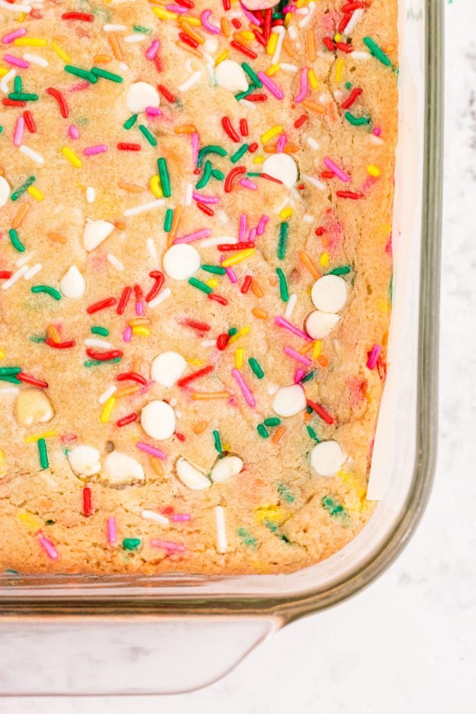 Blonde with birthday cake in baking tray