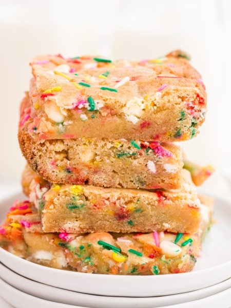 Birthday Cake Blondies stacked on a plate