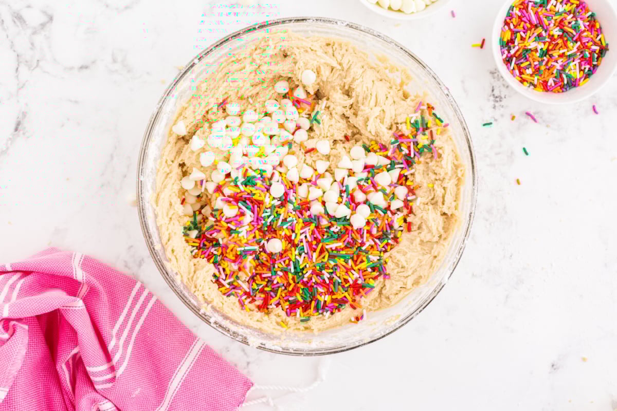 Add sprinkle and white chocolate chips to a bowl