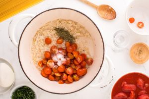 cherry tomatoes, salt and Italian seasoning added to pot