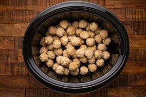frozen meatballs placed in slow cooker