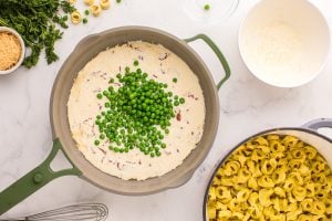 cream mixture and peas added to pan