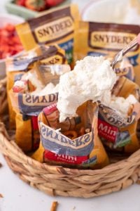 scooping cream cheese mixture into pretzel bags