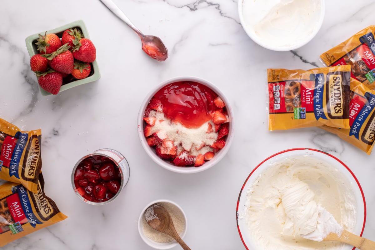 Thinly sliced strawberries, granulated sugar and strawberry pie syrup in another bowl