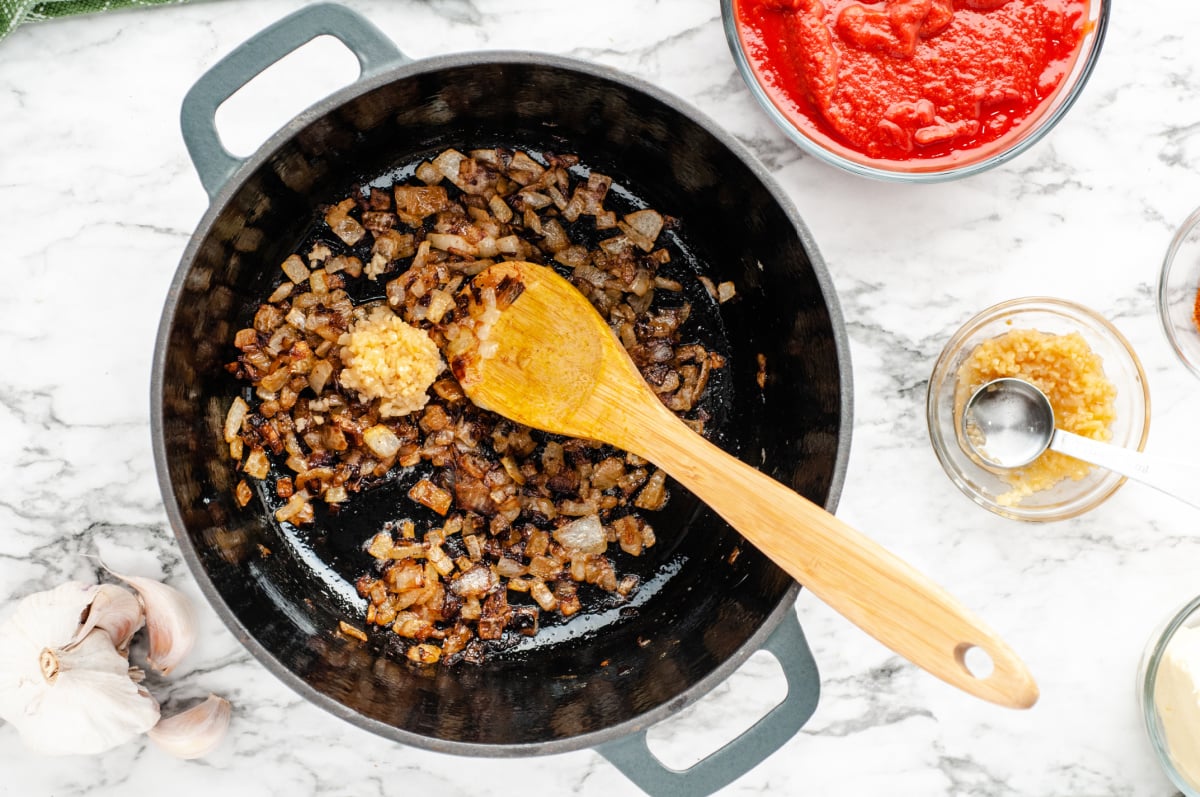 Add chopped garlic to the onion pot