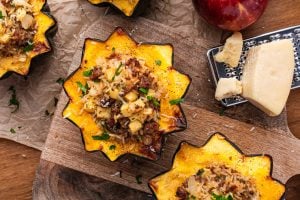 Sausage Stuffed Acorn Squash on parchment paper