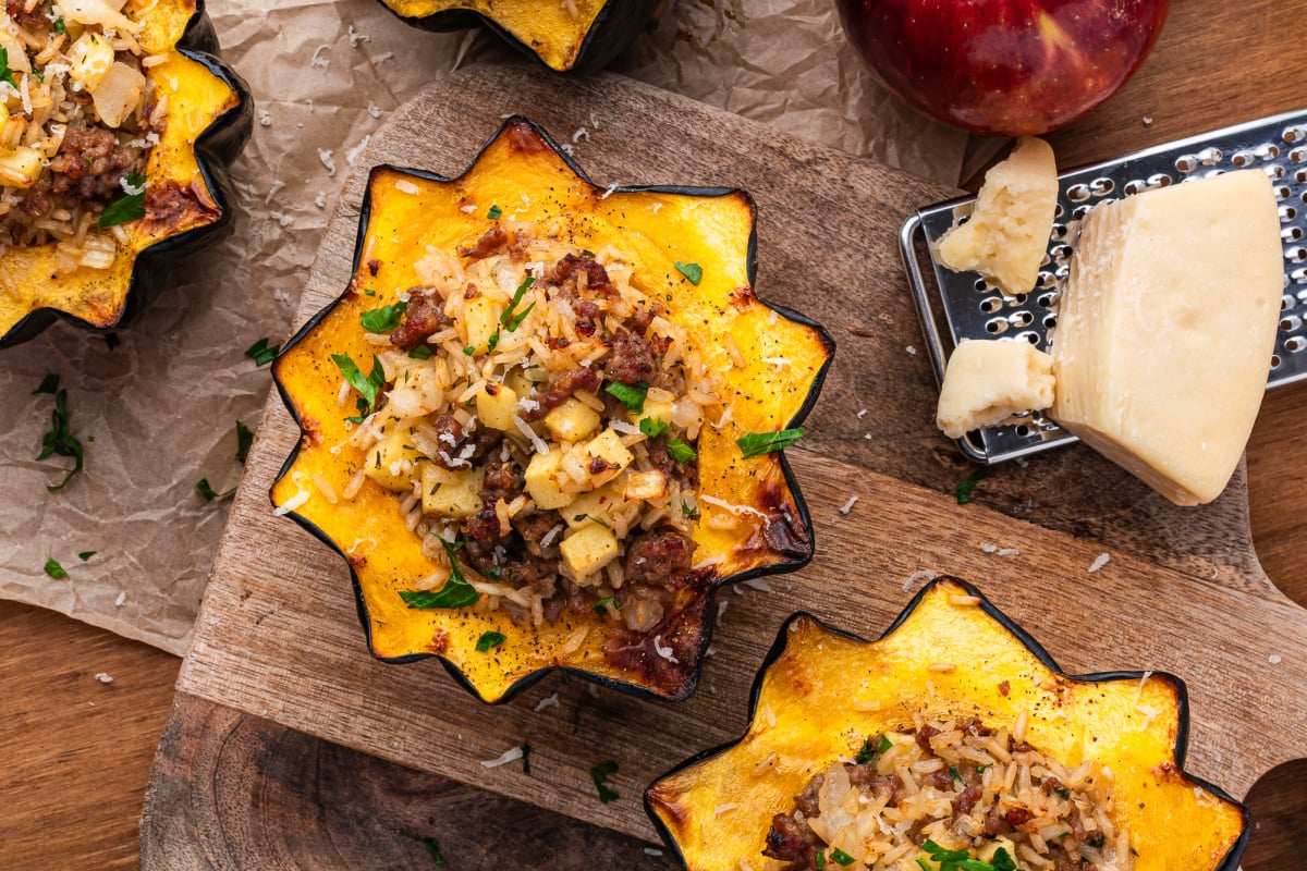 Sausage stuffed acorn pumpkin on parchment