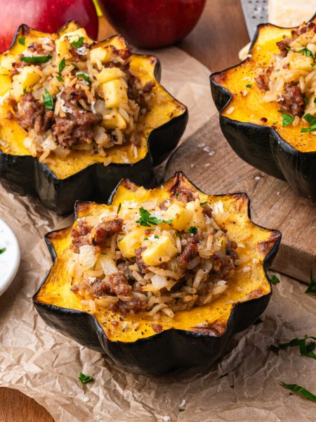 Sausage Stuffed Acorn Squash on parchment paper