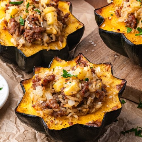 Sausage stuffed acorn pumpkin on parchment
