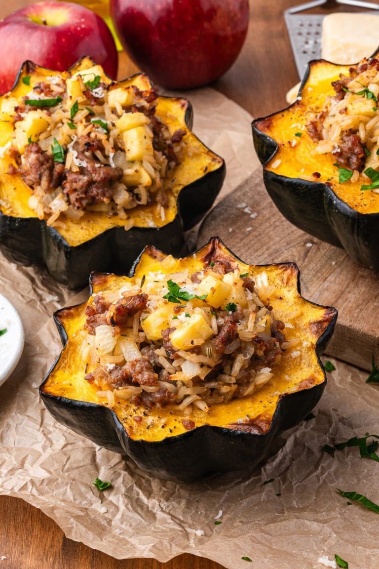 Sausage Stuffed Acorn Squash on parchment paper