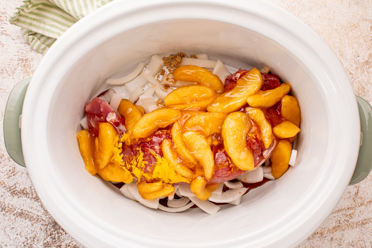 Apple pie filling, mustard sauce, seasoning added to the slow cooker
