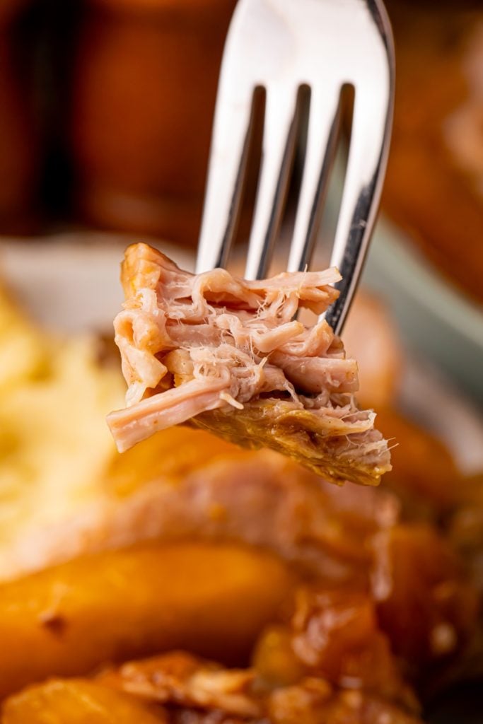 Pick up a piece of pork with a fork