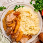 Slow Cooker Apple Pie Pork Tenderloin on a plate with mashed potatoes